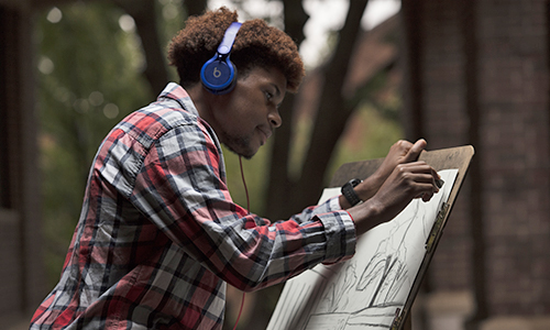 Student sketching in front of Olin Library.