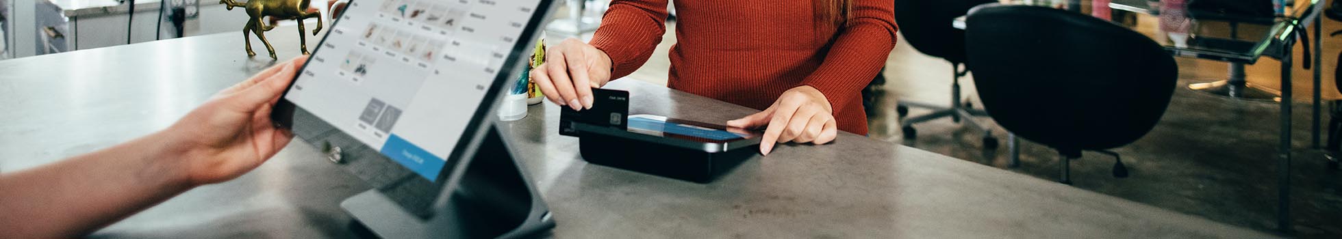 Woman swiping a credit card.