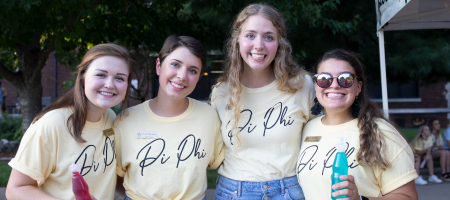 Four girls in Pi Pi shirts.