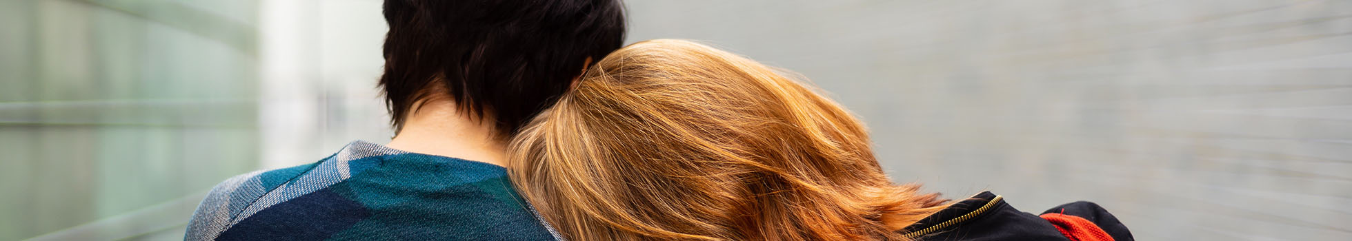 Woman and boy leaning on each other.