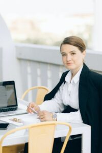 Woman in Black Blazer Sitting on Chair