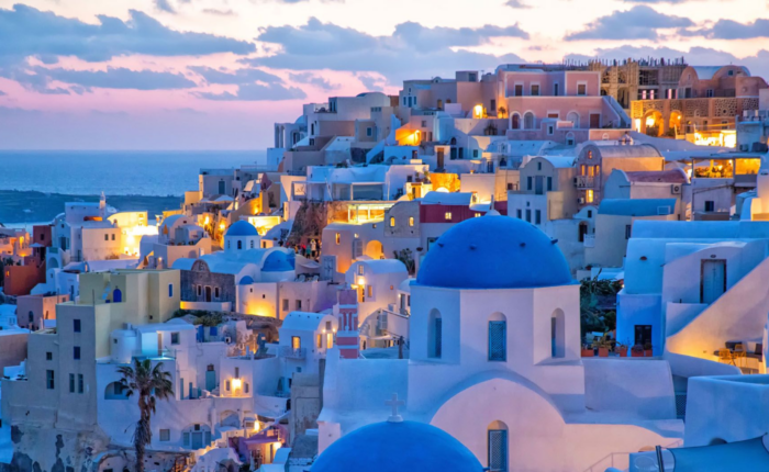 Buildings with blue roofs in Greece during sunset