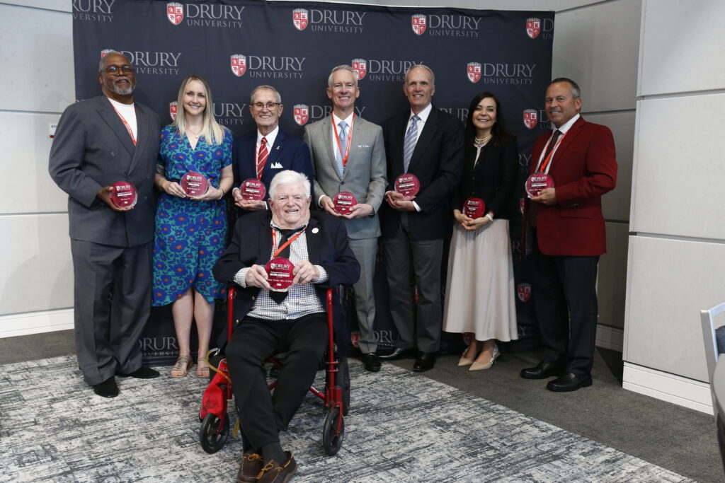 Front row: Edwin "Cookie" Rice '52/H'20 Back row (left to right): Wes Pratt '73, Kelly Sitzman '10, Michael "Mike" White '61, Basil "Trent" Webb '89, Lynn Chipperfield '73, Rita Baron '99, and Jeffrey "Jeff" Bohannan '84