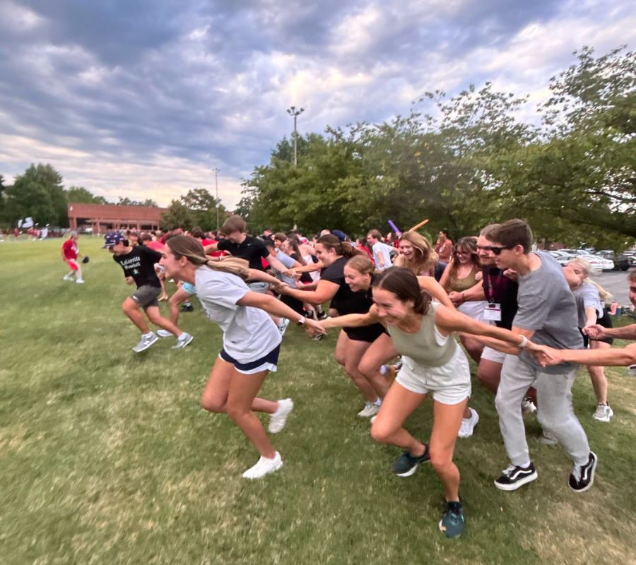Students playing a game together in Kellogg Field