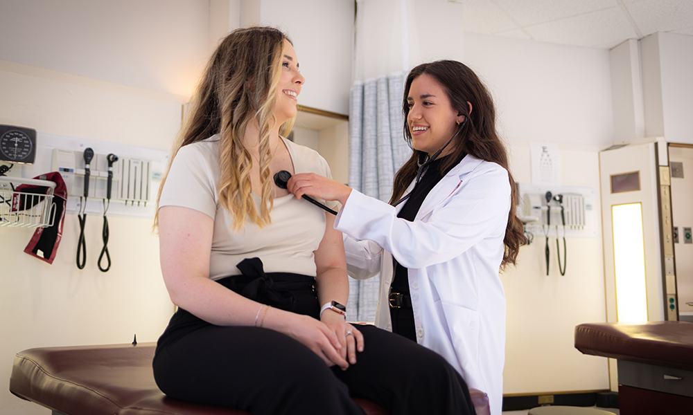 A physician assistant student giving an exam to a patient in a clininc